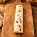 Brazo de chocolate blanco sobre madera | Tu Obrador Tarragona