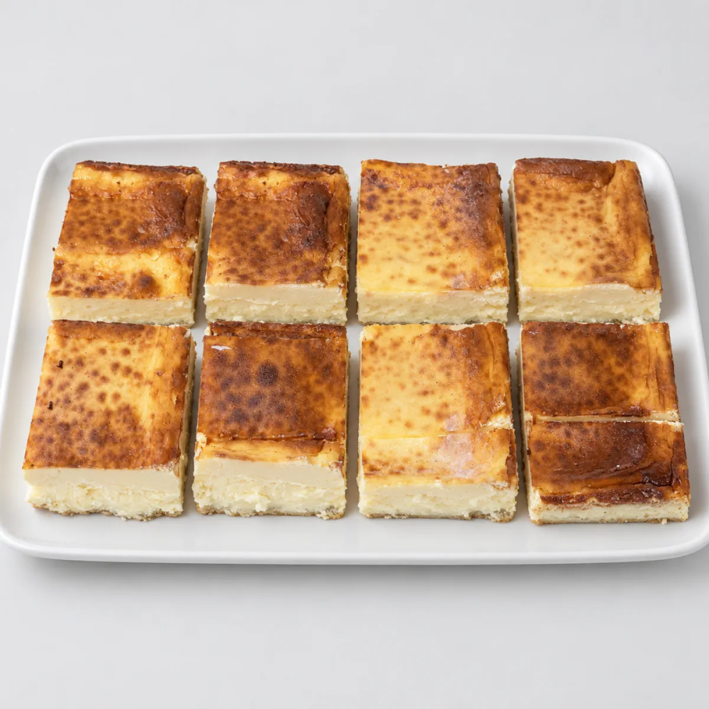 Porciones de tarta de queso al horno con base de galleta - Tu Obrador Tarragona